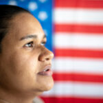 portrait-of-woman-with-american-flag-on-background